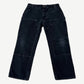 Vintage Carhartt faded black double knee carpenter pants with brass rivets and utility pockets, front view