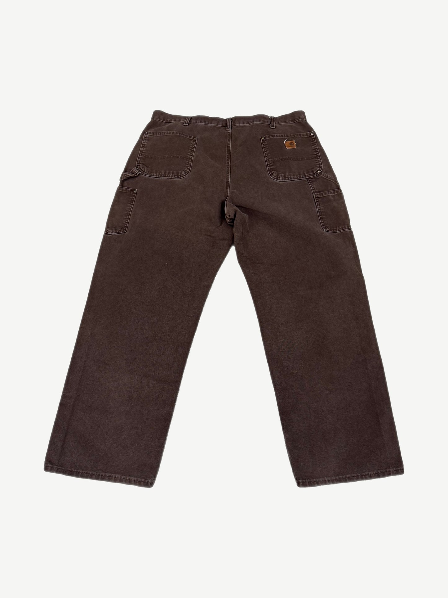 Vintage Carhartt faded brown canvas double-knee work pants with utility pockets and leather waist tab.