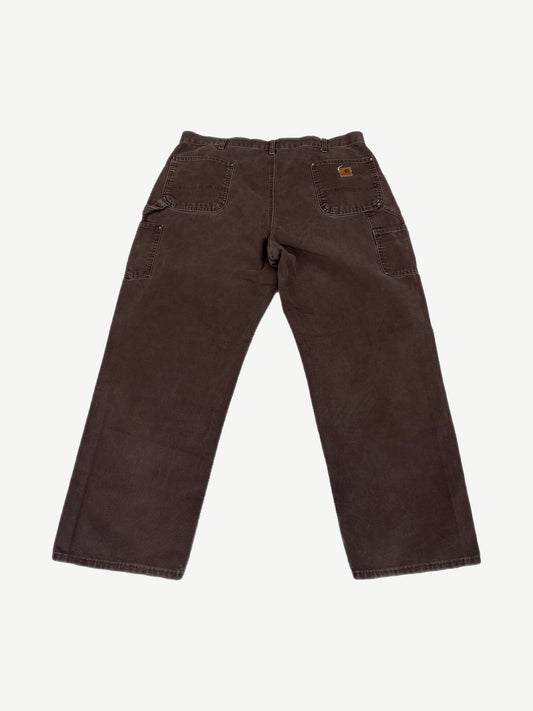 Vintage Carhartt faded brown canvas double-knee work pants with utility pockets and leather waist tab.