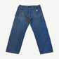 Back of vintage Carhartt denim double knee carpenter pants with branded leather label and patch pockets.