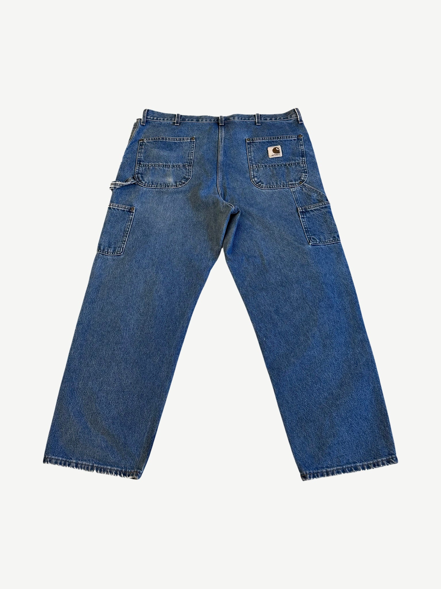 Back of vintage Carhartt denim double knee carpenter pants with branded leather label and patch pockets.