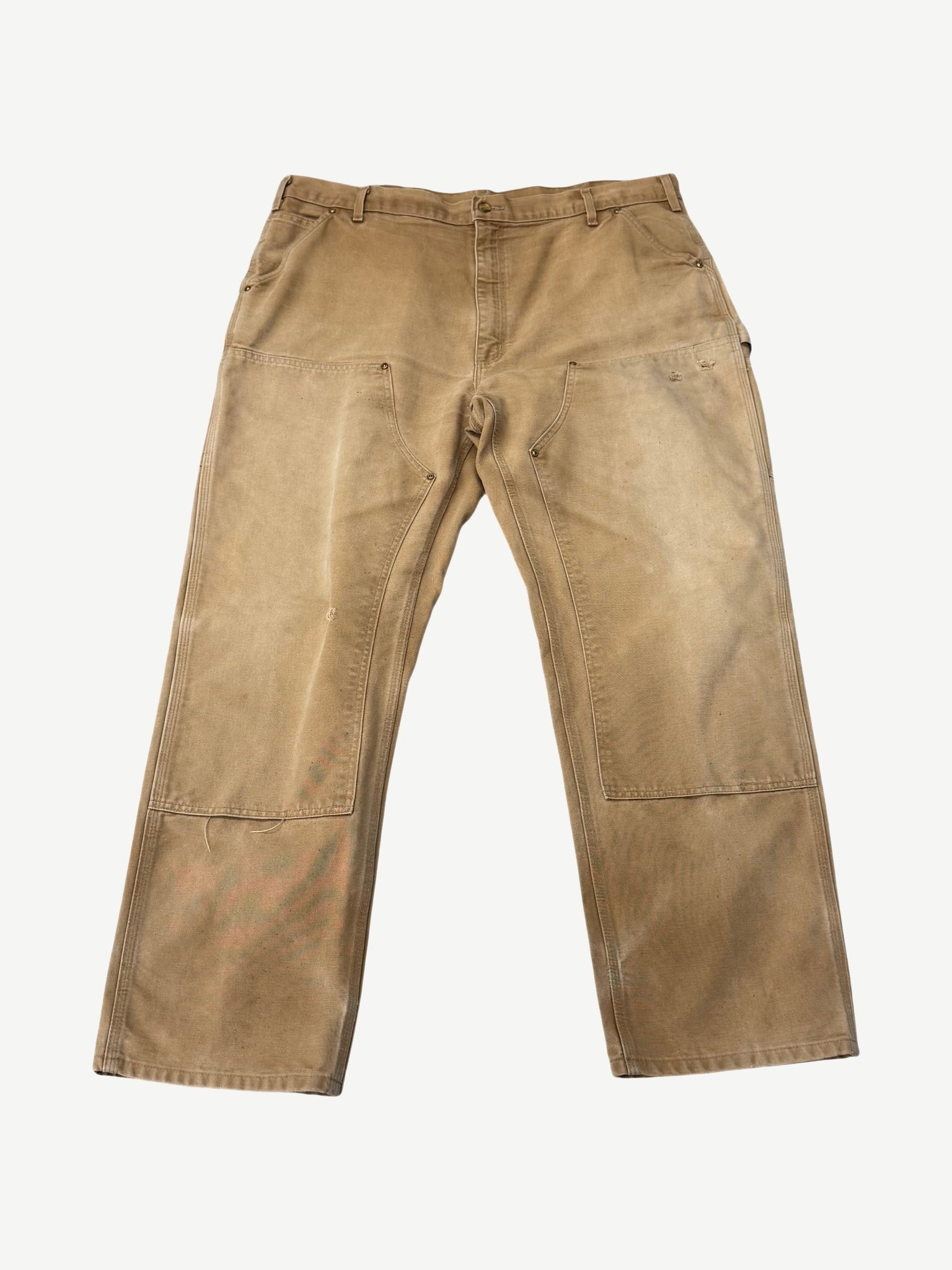 Vintage Carhartt tan double knee carpenter pants front view with faded duck canvas and reinforced knees
