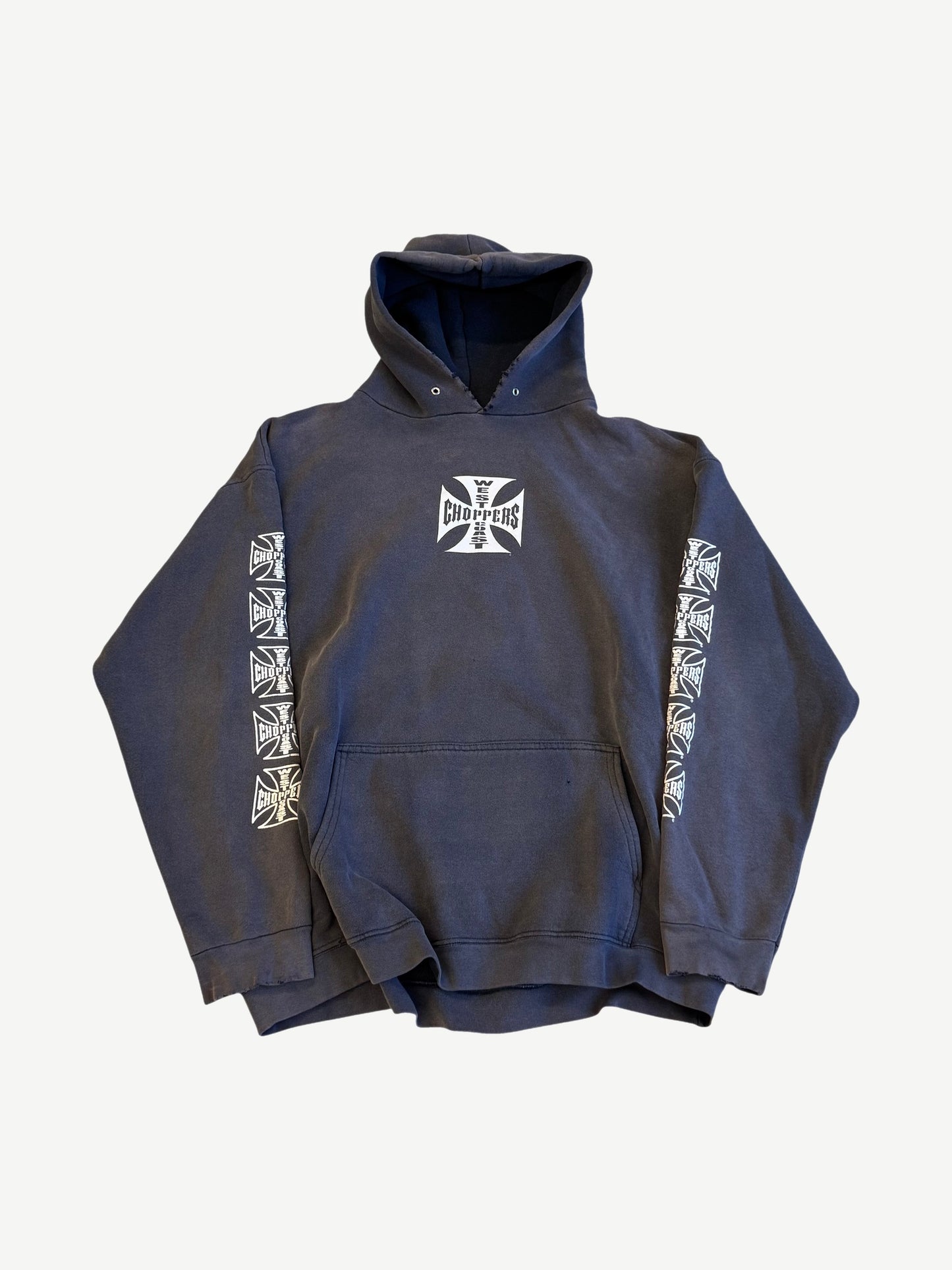 Vintage West Coast Choppers hoodie in sun-faded navy with iron cross chest logo and stacked sleeve prints.