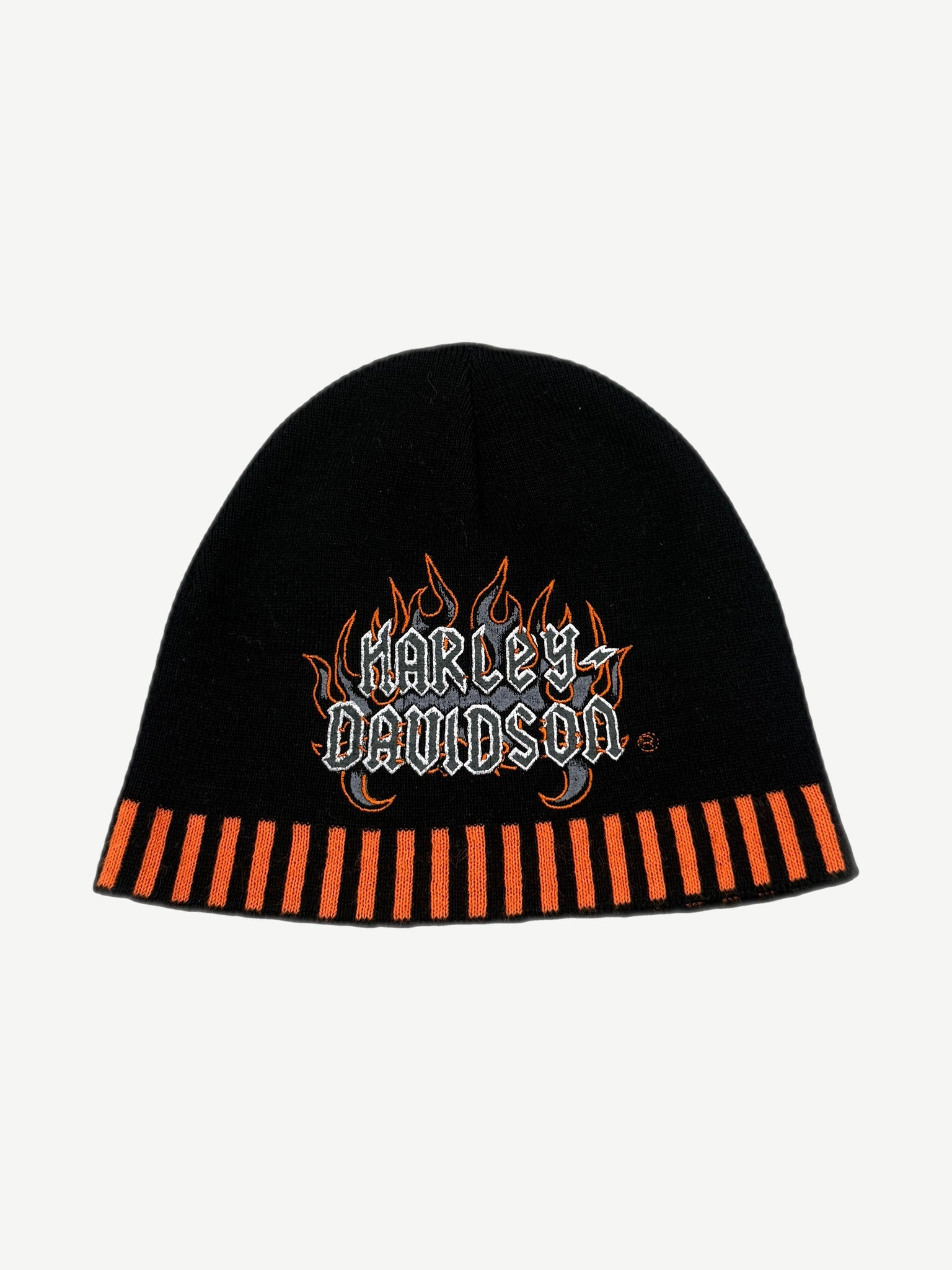 Vintage Harley-Davidson black knit beanie front with embroidered flame logo and orange piano-key cuff stripes