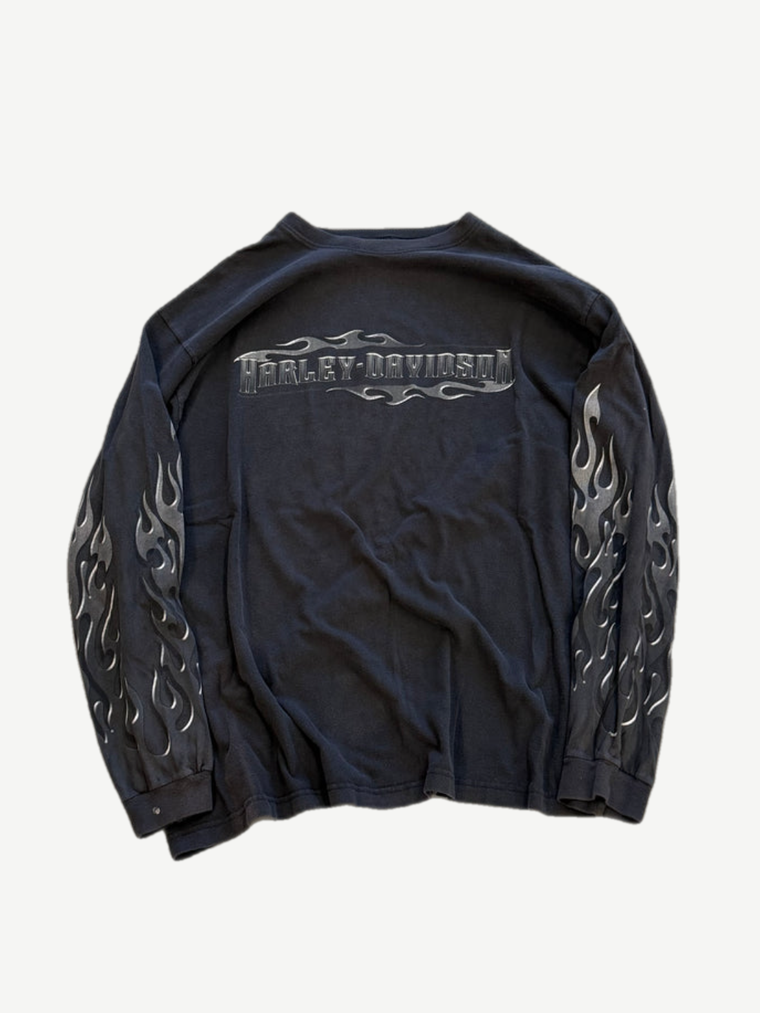 Vintage Harley Davidson black longsleeve front with silver flame sleeve graphics and faded crewneck collar.