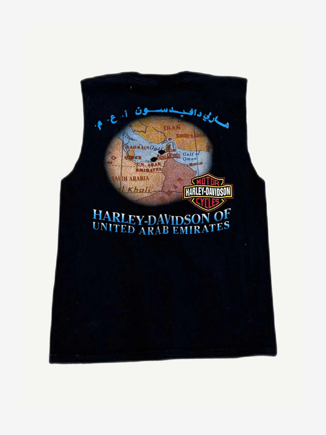 Back of vintage Harley Davidson UAE cutoff tee showing dealership graphic and raw cut sleeves.