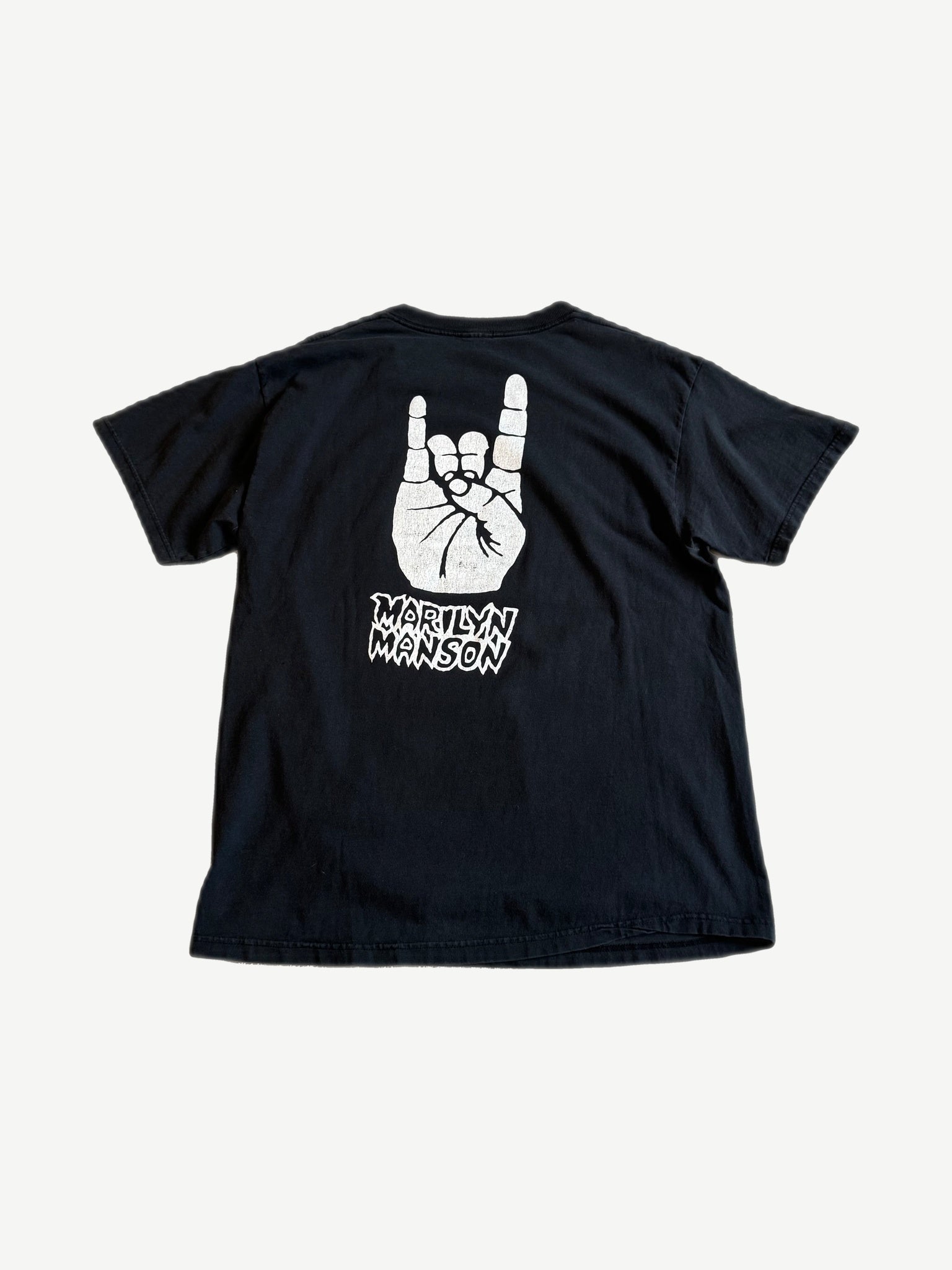 Vintage Marilyn Manson black tee back with white rock devil horns hand sign and jagged Marilyn Manson logo print.
