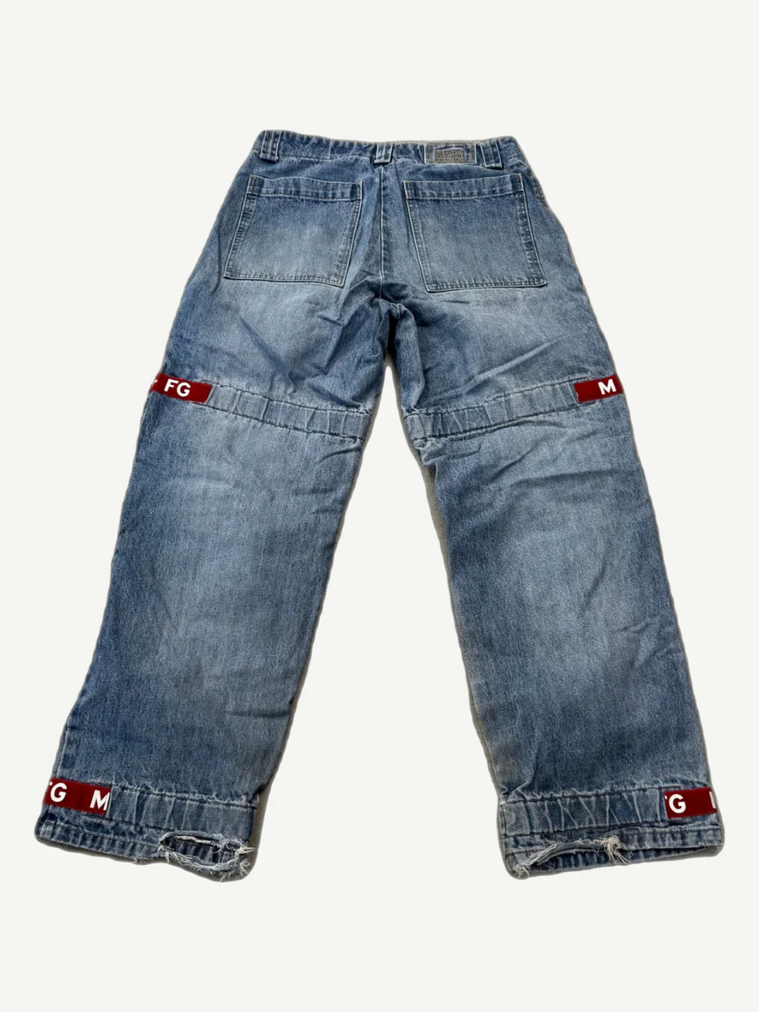 Vintage Girbaud light wash baggy jeans back view with red signature ribbon strap detailing at cuffs