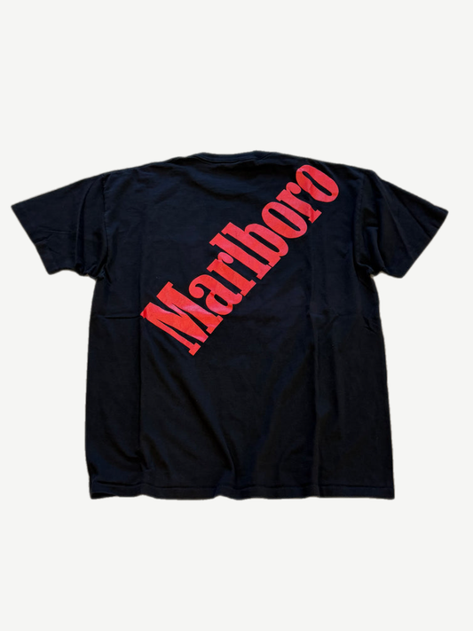 Vintage Marlboro big logo tee back, large red diagonal Marlboro wordmark print across black cotton body.