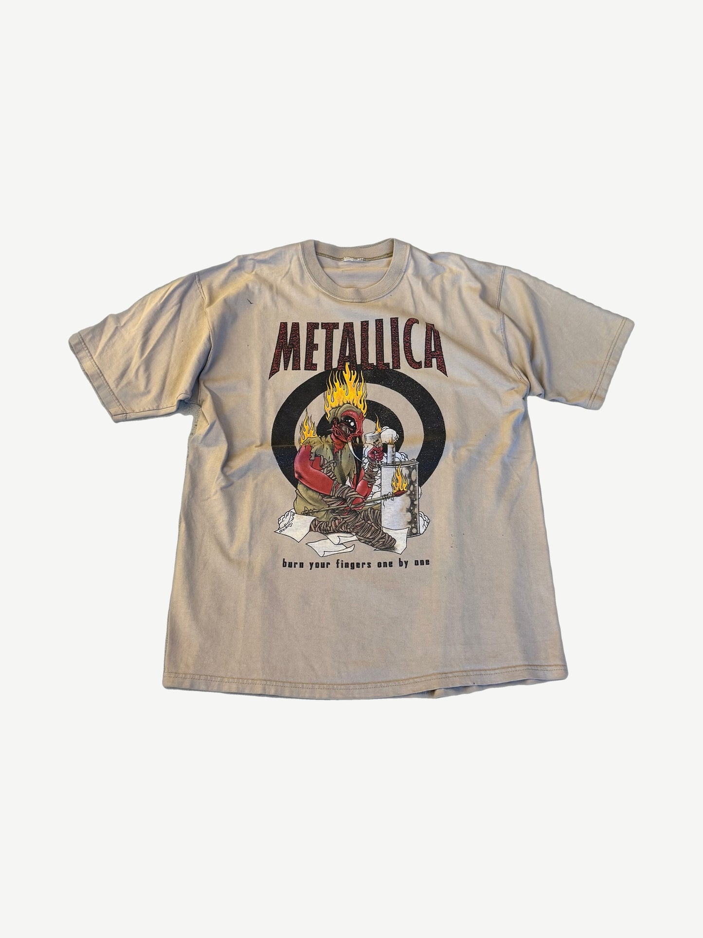 Vintage Metallica Burn Your Fingers tour tee in tan with flaming target graphic and red Metallica logo.