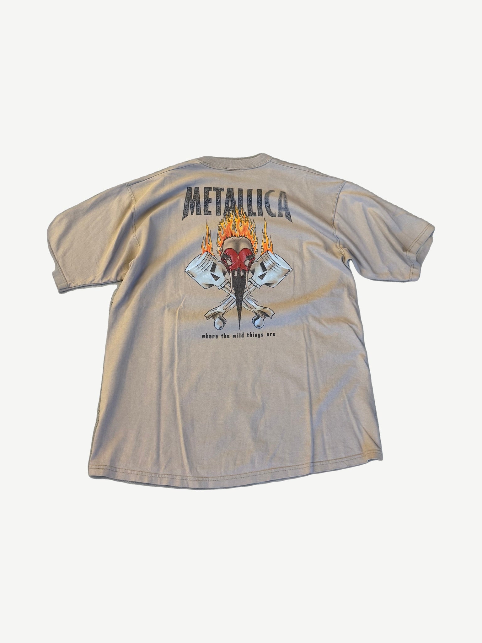 Back of vintage Metallica Burn Your Fingers tee with flaming skull and crossed pistons illustration.