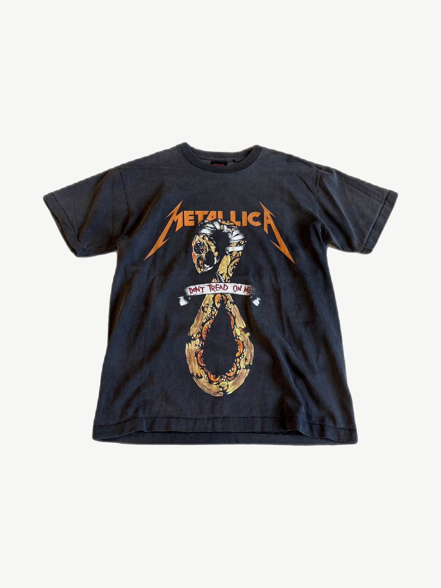 Vintage Metallica faded black tee front with coiled snake and Don't Tread On Me scroll graphic