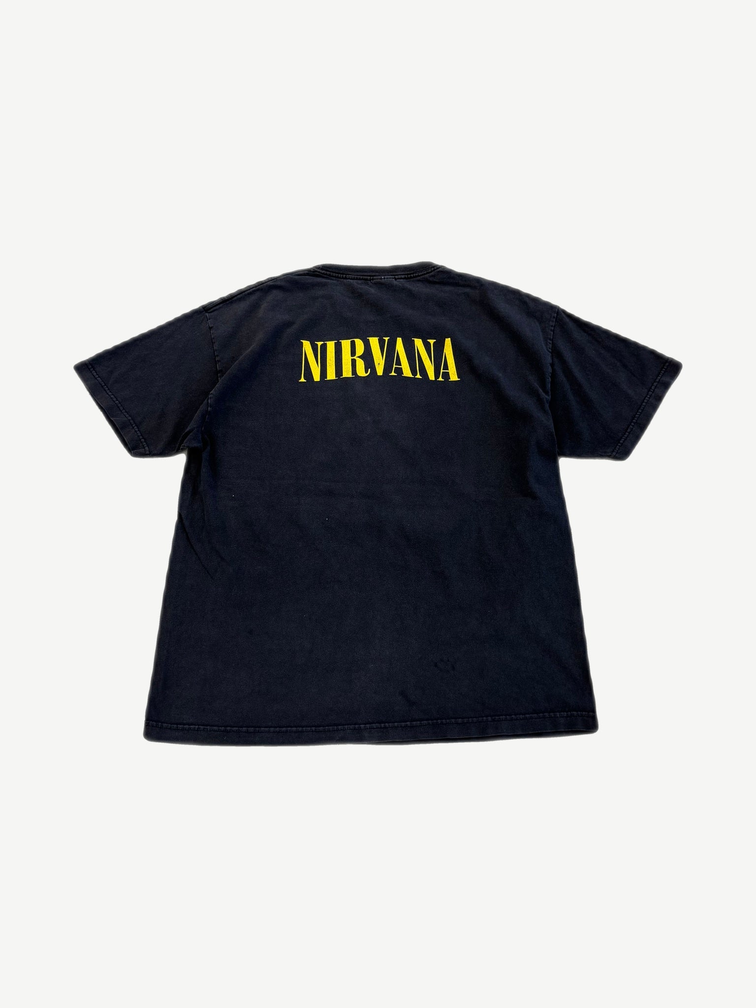 Vintage Nirvana black band tee back with yellow stencil Nirvana logo across upper shoulders.