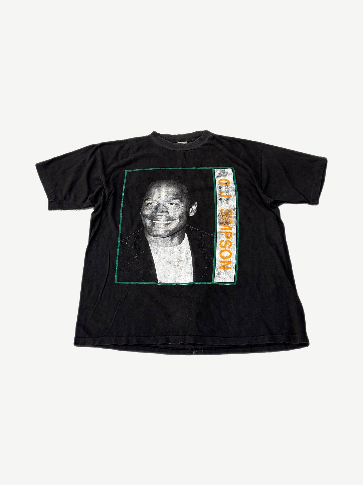 Vintage O.J. Simpson black tee with green-bordered portrait print and orange vertical name text