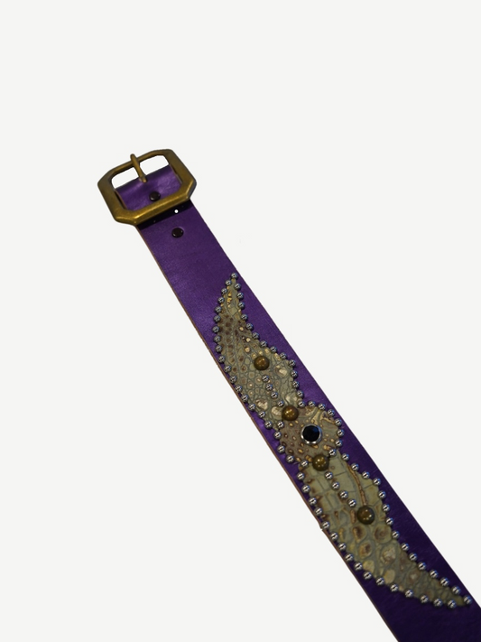 Buckle end of vintage purple studded belt with brass square buckle and embossed snakeskin panel detailing