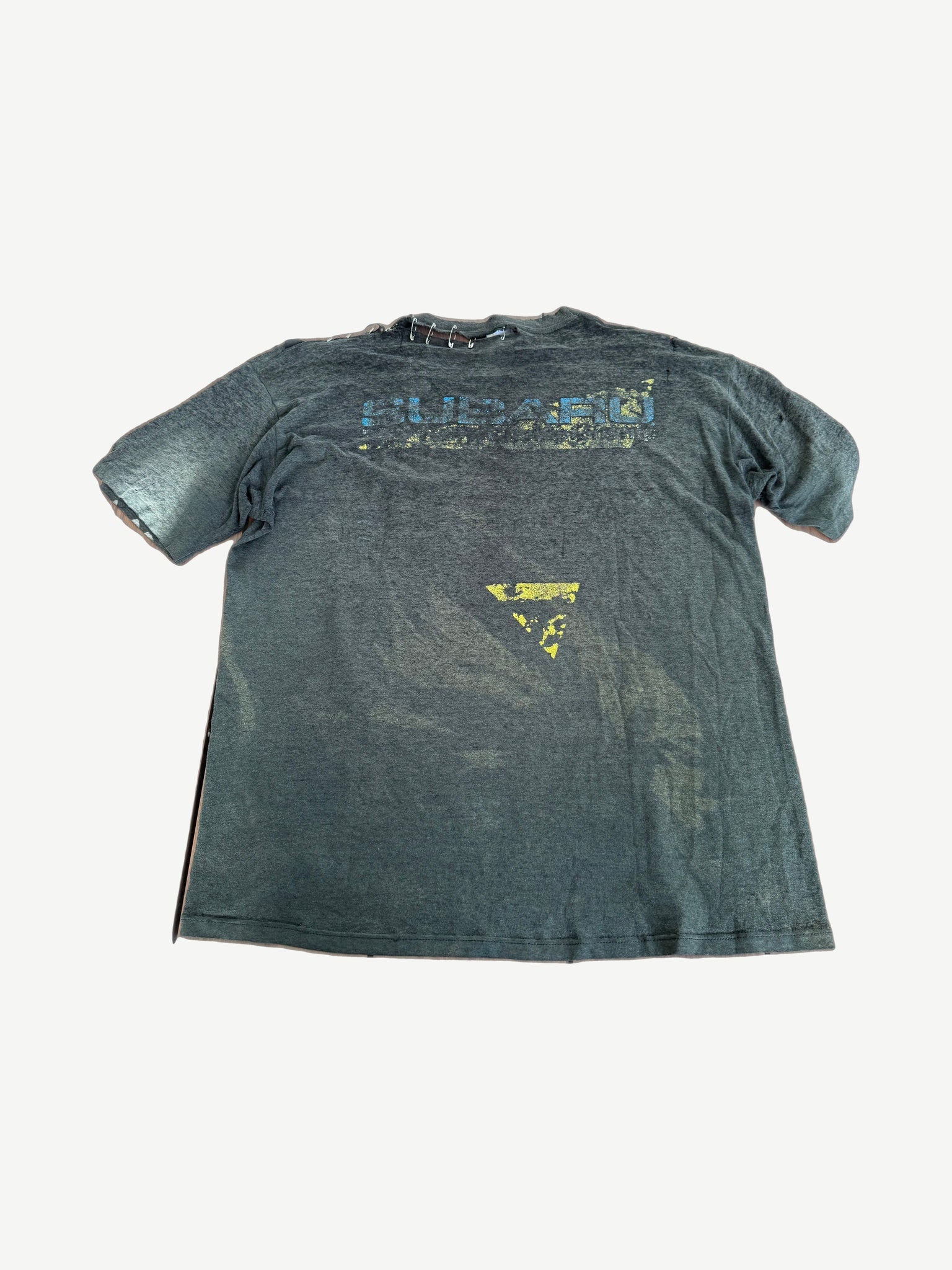Vintage Subaru faded black tee back with cracked Subaru logo print and rally car graphic.