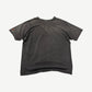 Back view of vintage washed black Punisher t-shirt with sun-faded gray tones and small orange sleeve graphic