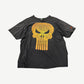 Vintage faded black Punisher tee with large orange distressed skull logo print across the chest