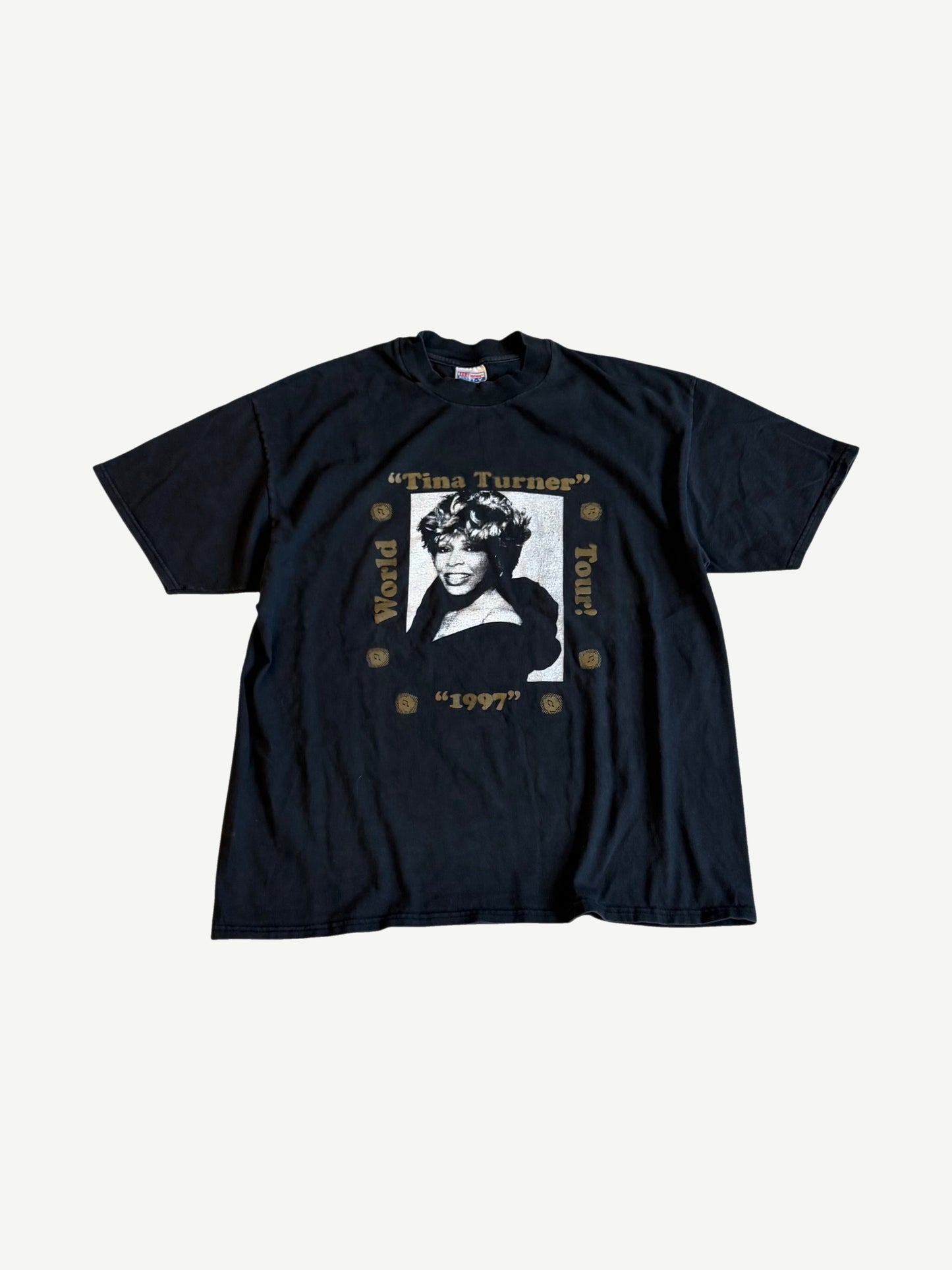 Vintage Tina Turner 1997 World Tour tee front in faded black with gold-framed portrait print and tour text