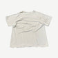 Back view of vintage distressed white Destination Anywhere tee with thrashed holes throughout body and sleeves