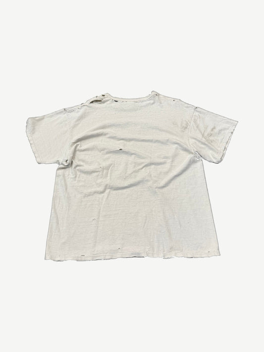 Back view of vintage distressed white Destination Anywhere tee with thrashed holes throughout body and sleeves