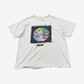 Vintage white tee with distressed holes and Destination Anywhere safety-pinned patch featuring quartered earth graphic