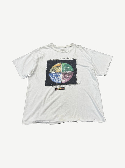 Vintage white tee with distressed holes and Destination Anywhere safety-pinned patch featuring quartered earth graphic