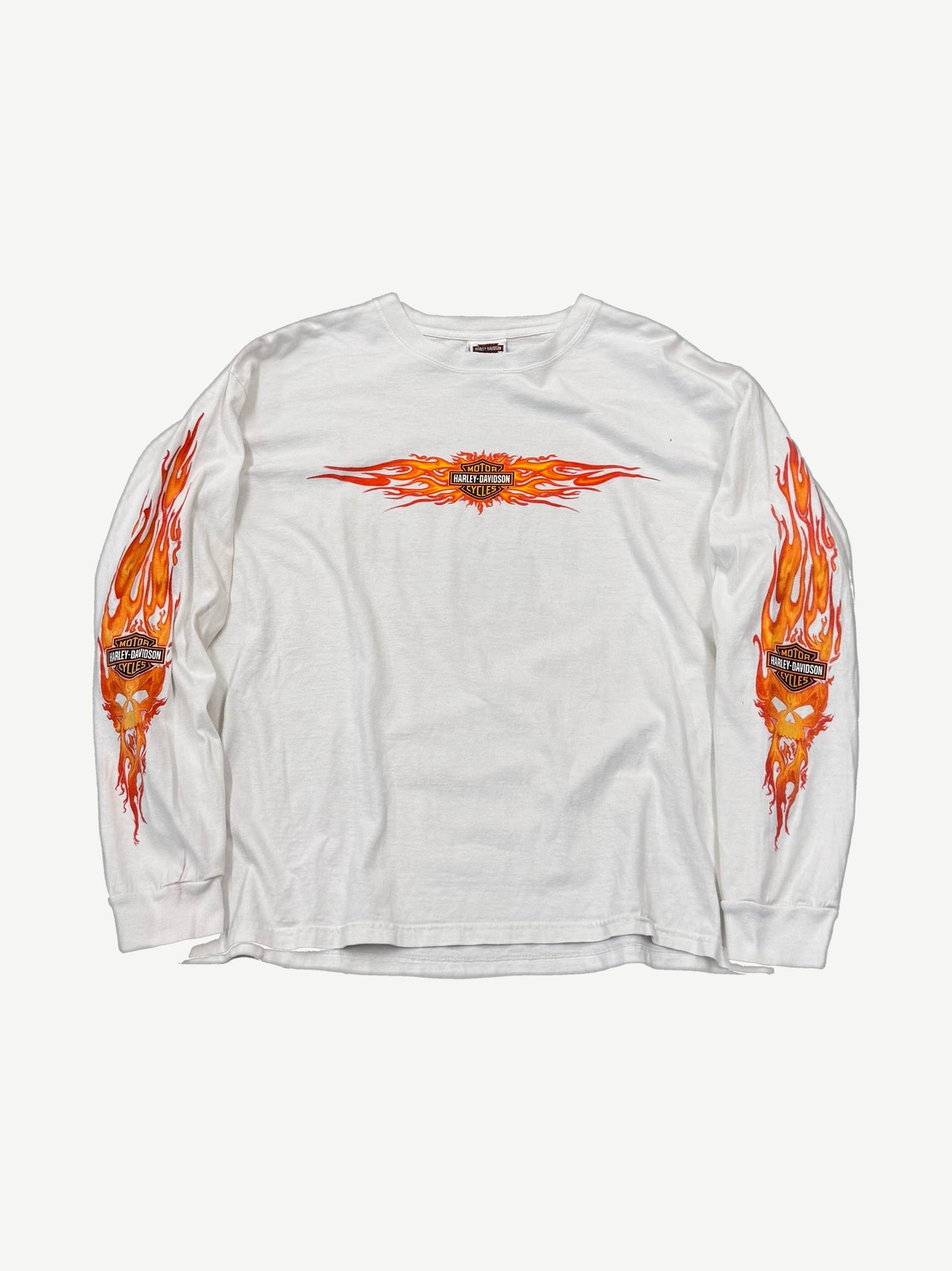 Vintage Harley-Davidson white longsleeve tee with orange flame bar-and-shield chest print and flaming skull sleeves.