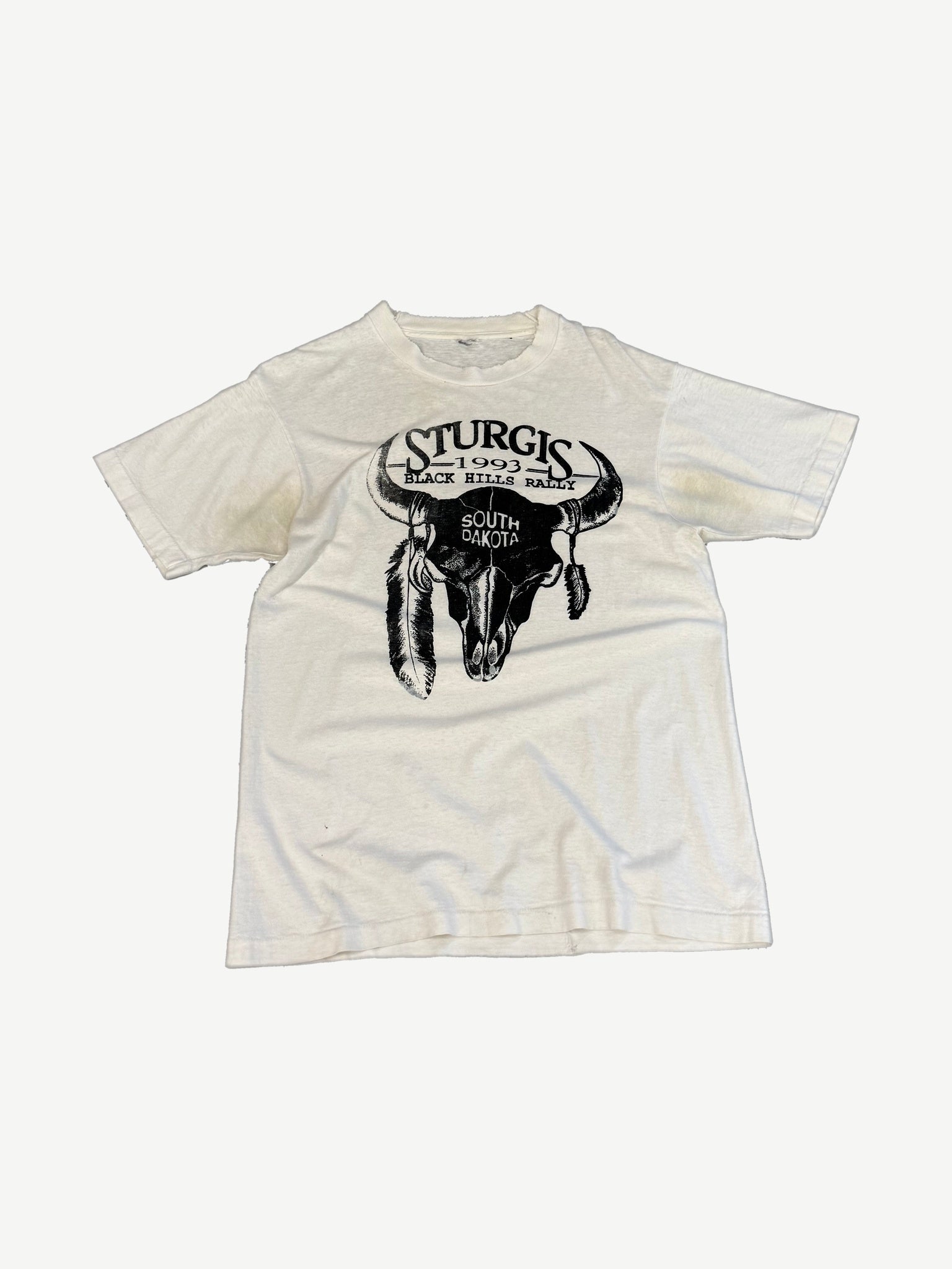 Vintage white Sturgis 1993 Black Hills Rally tee with bull skull and feathers graphic at center chest